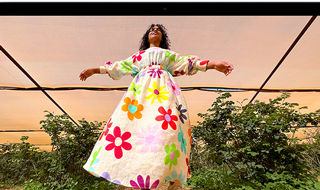 MacBook Air screen showing photo of person in colorful outfit, demonstrating color range and resolution of Liquid Retina display
